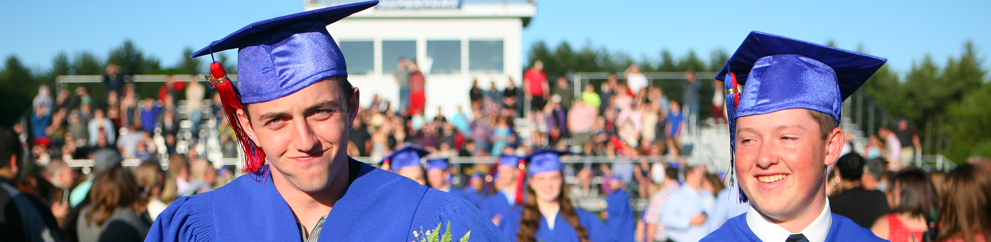 Two happy graduates walking together during graduation