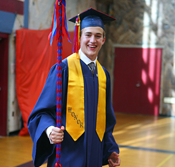 Happy graduate in cap and gown