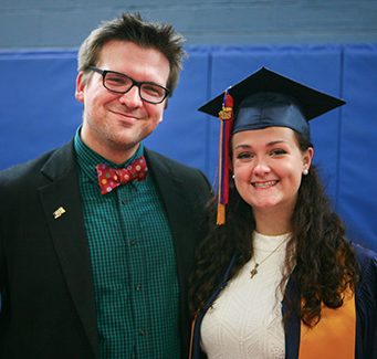 Proud adult next to recent graduate