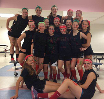 Group of spirited girls wearing black and neon hand bands